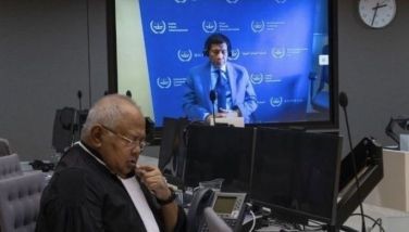Former Philippine President Rodrigo Duterte is seen on a screen with his lawyer Salvador Medialdea (L) in the courtroom during his first appearance before the International Criminal Court (ICC) on charge of crimes against humanity over his deadly crackdown on narcotics, in The Hague on March 14, 2025.